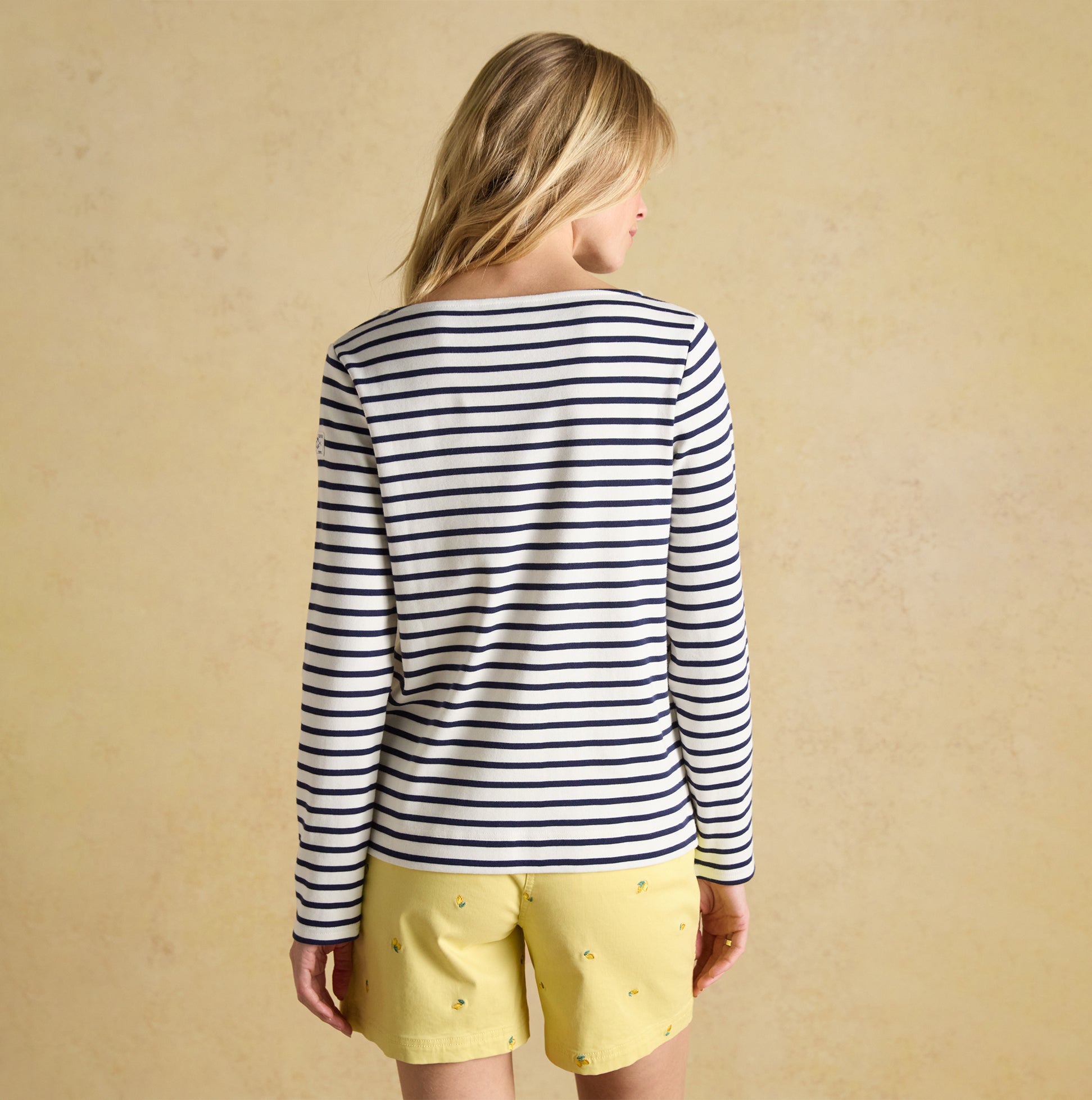 Joules HARBOUR Boat Neck 100% Cotton Breton Top Cream/Navy Stripe back view, worn with yellow shorts.