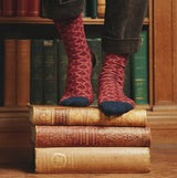 Joules EVERYDAY 2-Pack Womens Socks Navy Horse worn on feet atop vintage books, showcasing vibrant color and design.