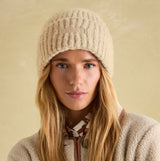 Joules CAVERSHAM Womens Beanie Oat front view worn by model, showcasing its textured design and cozy material.