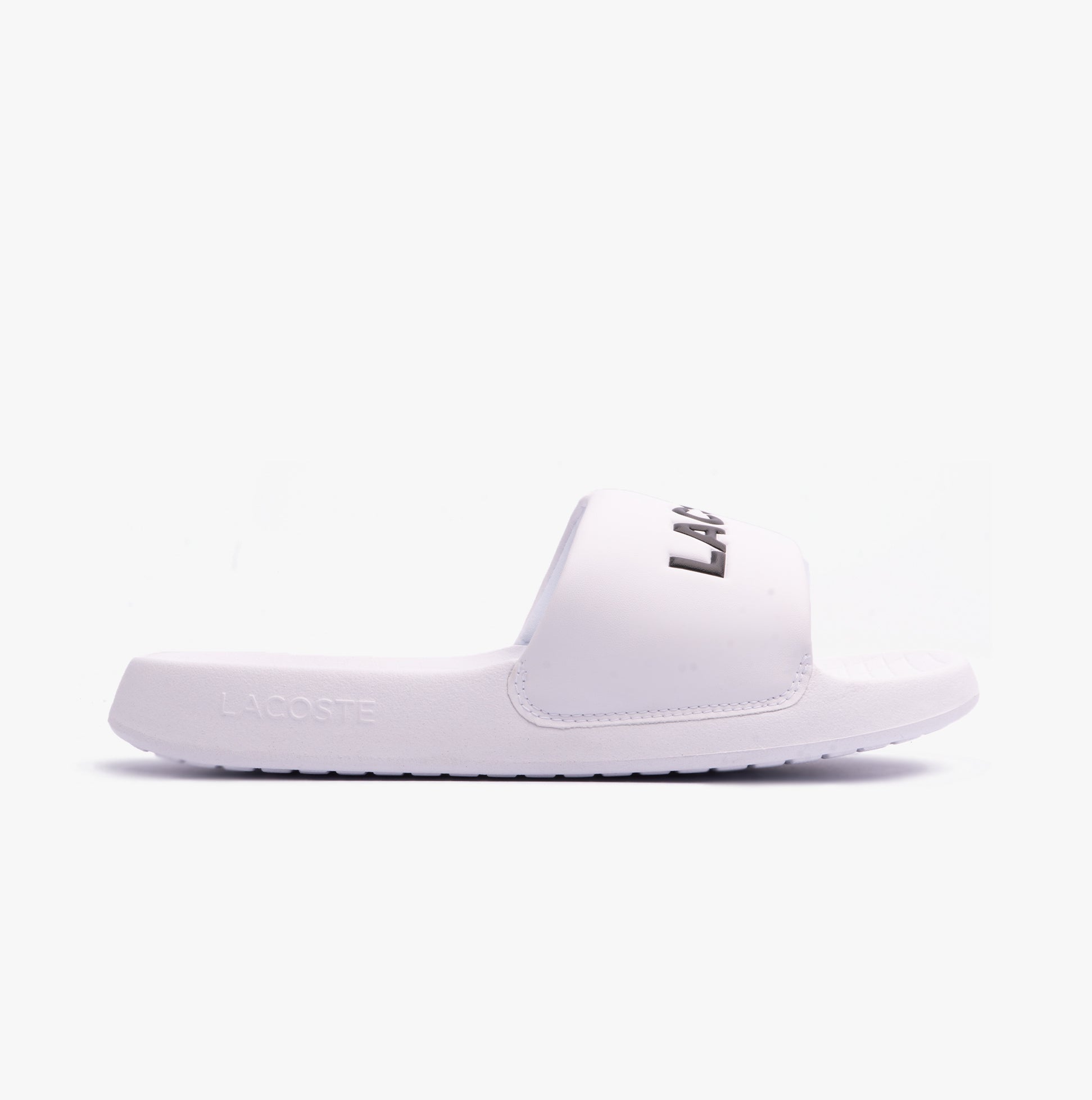 Lacoste SERVE SLIDE 1.0 124 2 Mens Slides White/Black side view showing EVA upper and slip-on design.