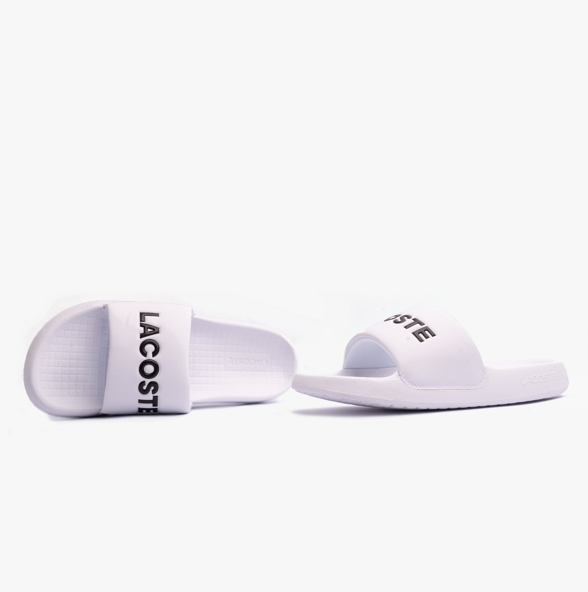 Lacoste SERVE SLIDE 1.0 124 2 Mens Slides White/Black side view showcasing the slip-on design and logo.