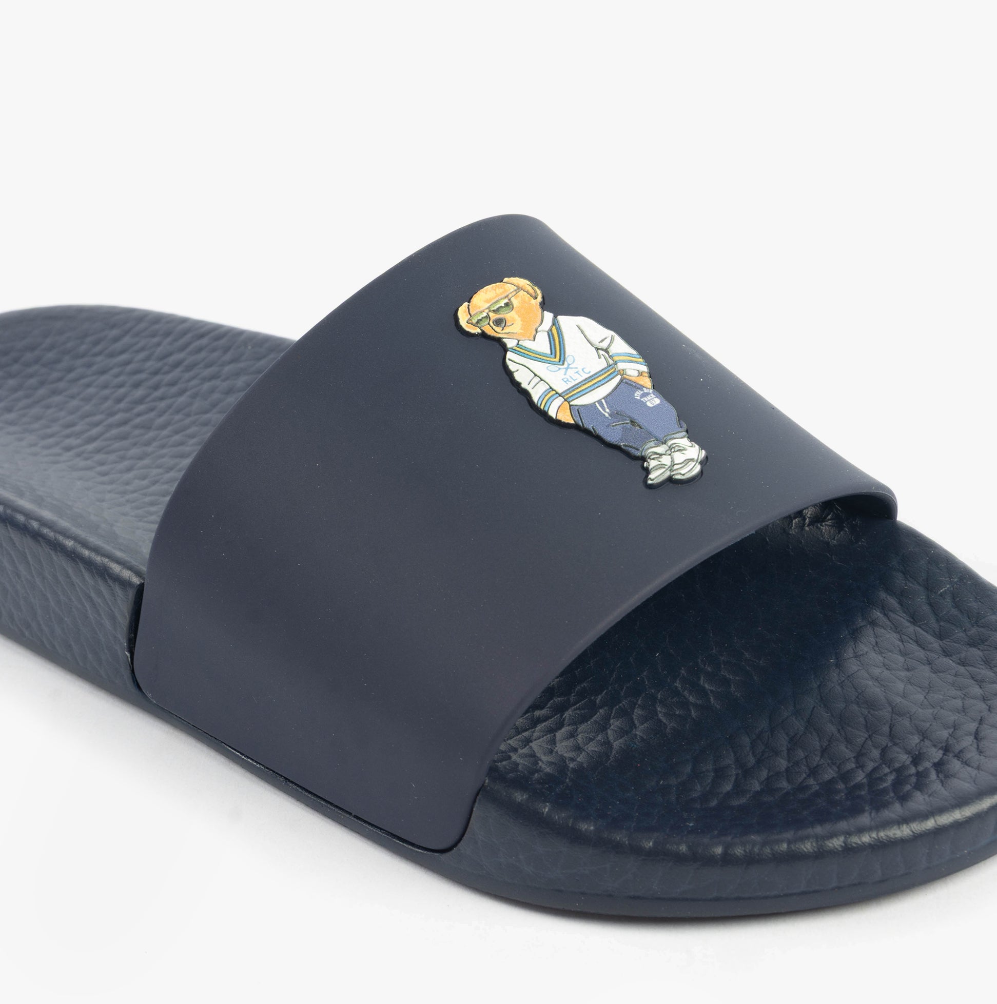 Polo Ralph Lauren POLO SLIDE Mens Sliders Heritage Bear Navy detail view featuring iconic bear design on a navy slide.