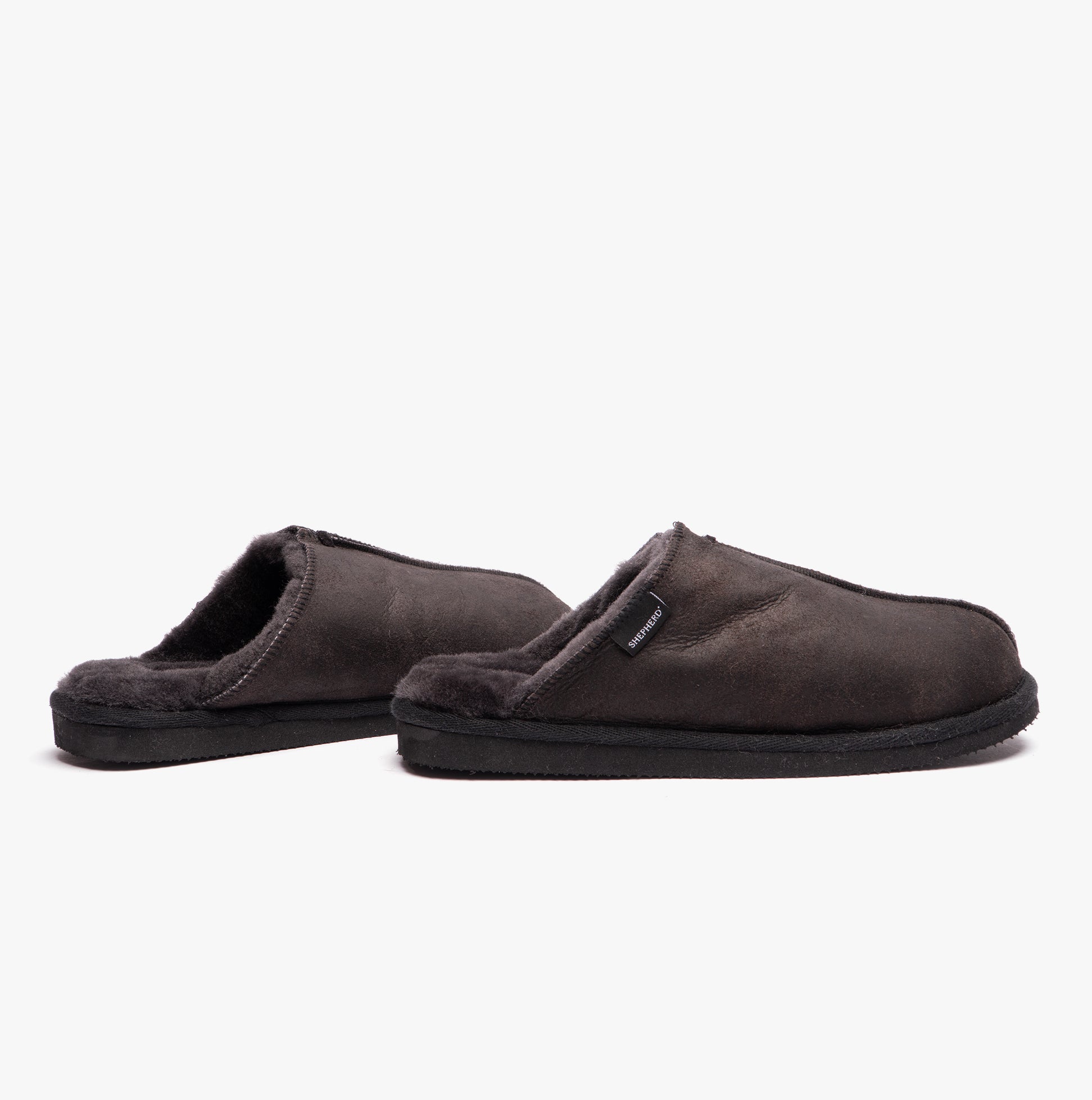 Shepherd HUGO Mens Sheepskin Mules Black side view showcasing the soft sheepskin upper and slip-on design.