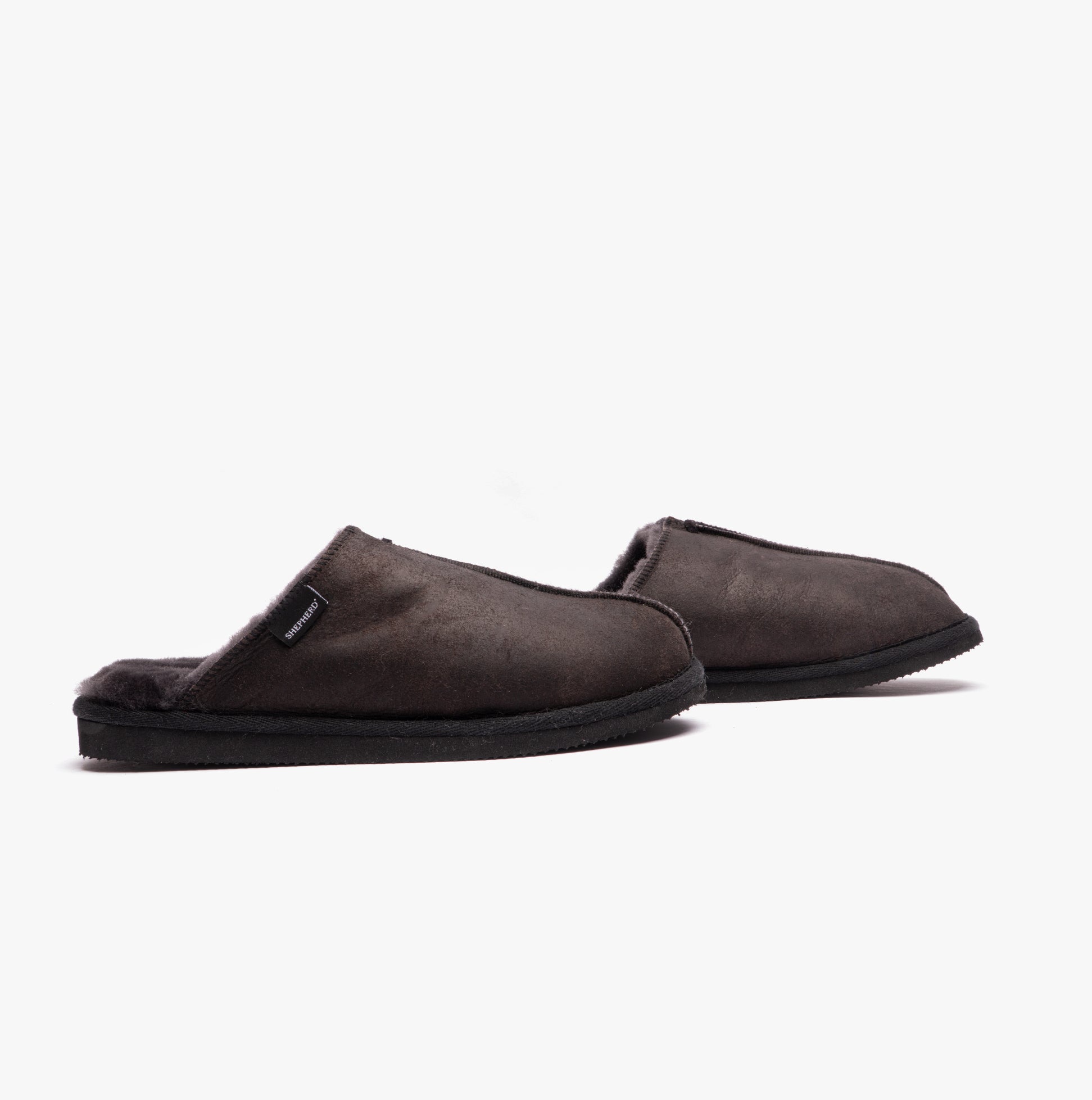 Shepherd HUGO Mens Sheepskin Mules Black side view showcasing their soft upper and warm lining.