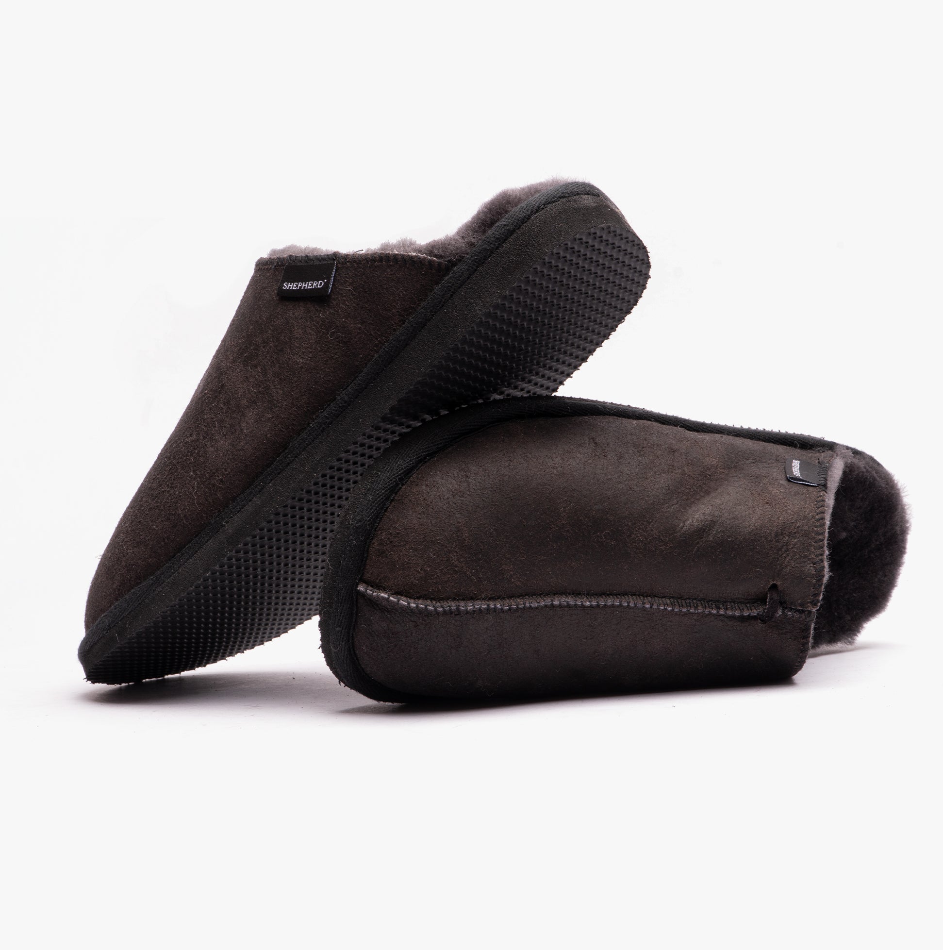 Shepherd HUGO Mens Sheepskin Mules Black side view showcasing soft sheepskin material and durable EVA sole.