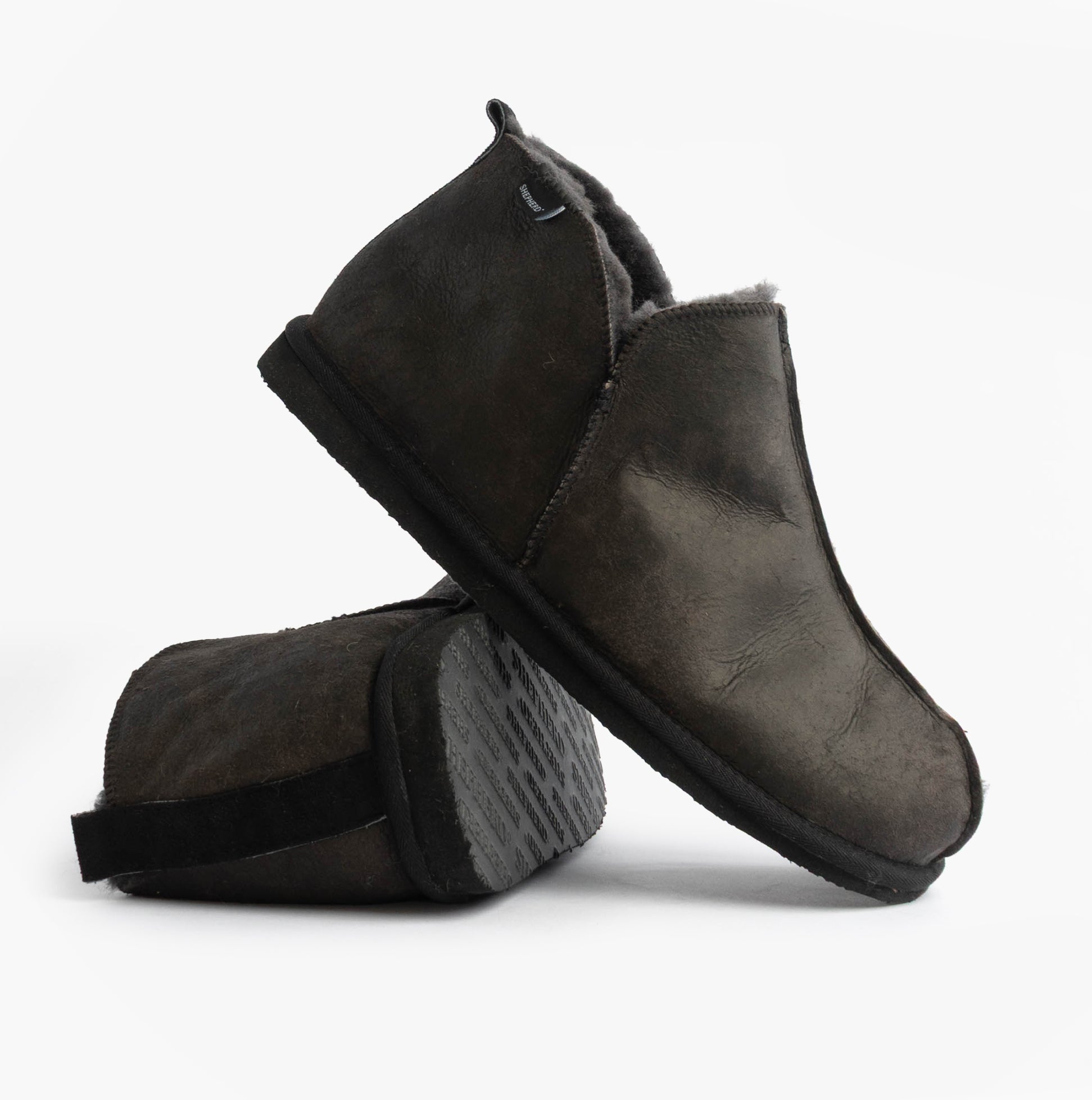 Shepherd ANTON Mens Slippers Matt Black side view showcasing leather and suede upper with a flat rubber sole.