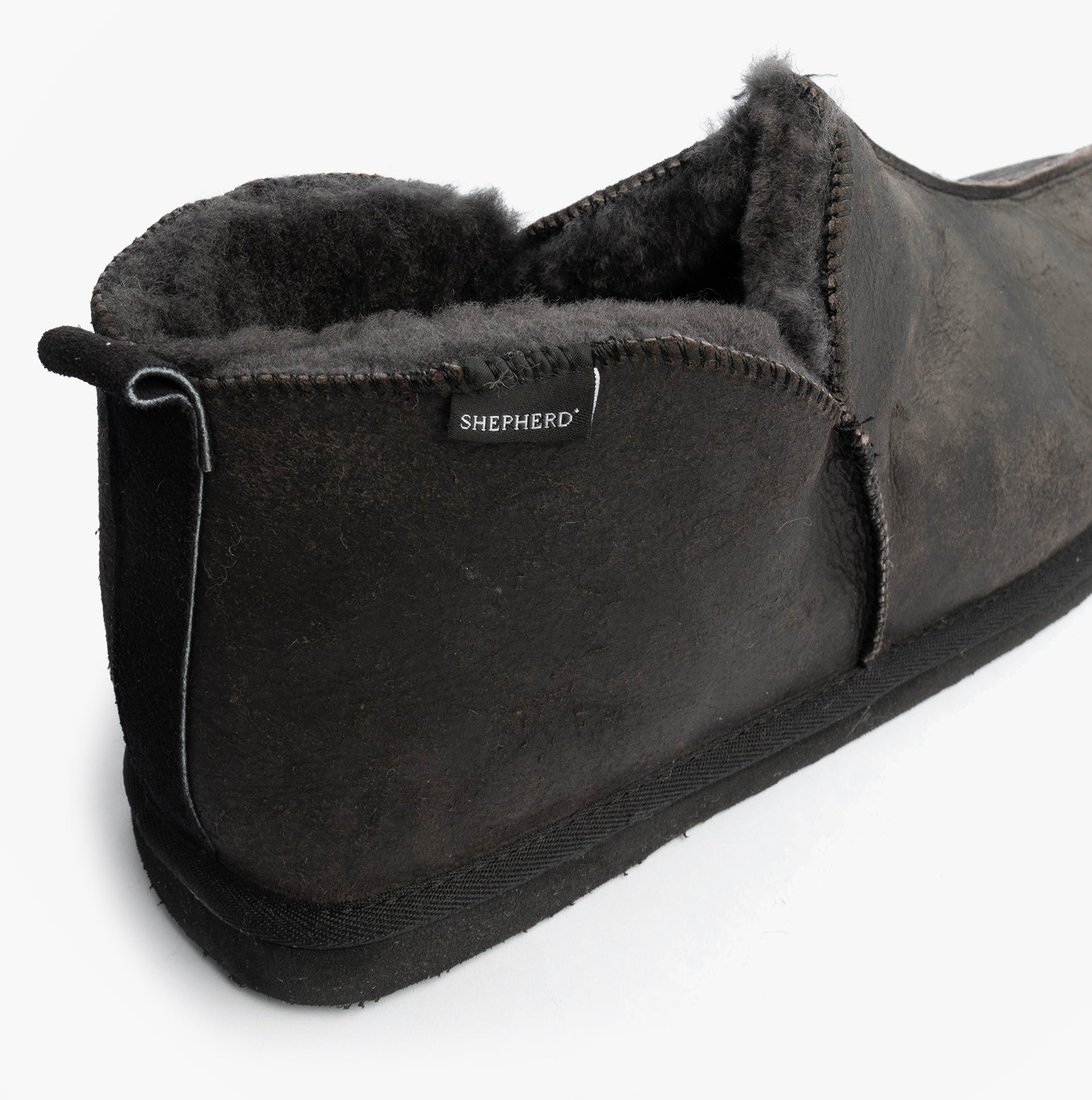Shepherd ANTON Mens Slippers Matt Black side view showcasing the leather and suede design with textile lining and rubber sole.
