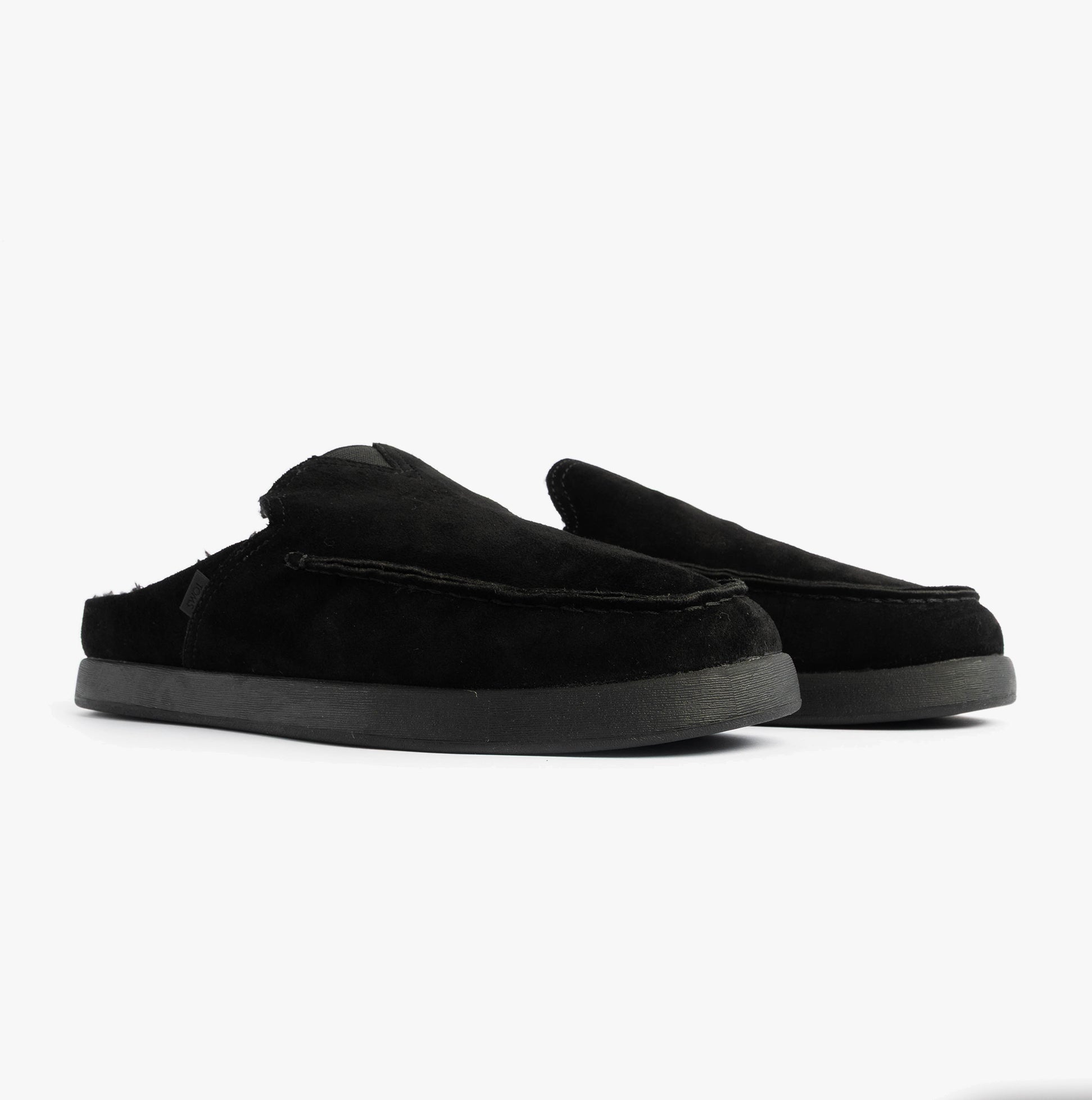 TOMS ALONSO MULE Mens Faux Shearling Lined Slippers Black side view of suede leather mules with rubber sole
