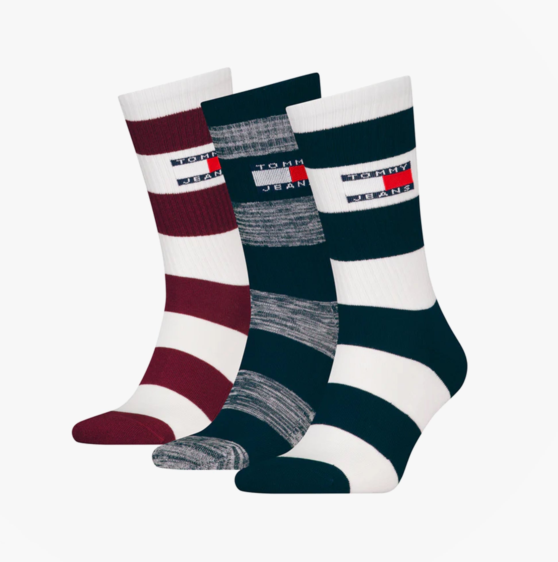 Tommy Hilfiger 3 Pack Trainer Stripe Mens Crew Socks Multi in side view showcasing red, gray, and navy stripes.
