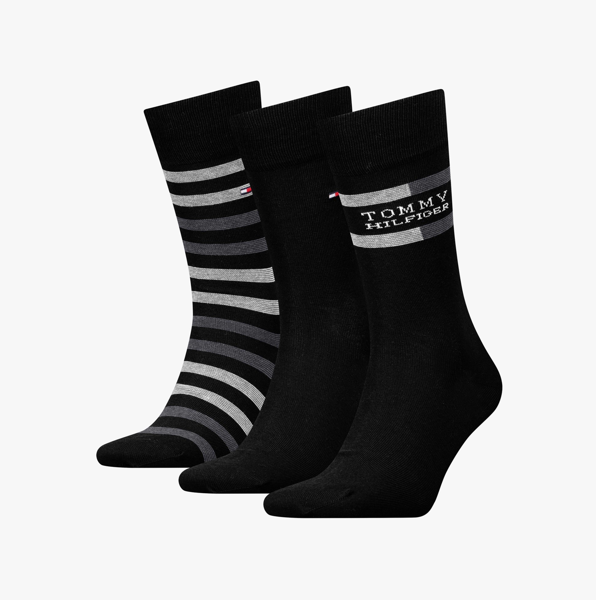 Tommy Hilfiger 3 Pack Giftbox Tommy Stripe Mens Socks Black featuring a front view of three pairs of crew socks in varying black designs.
