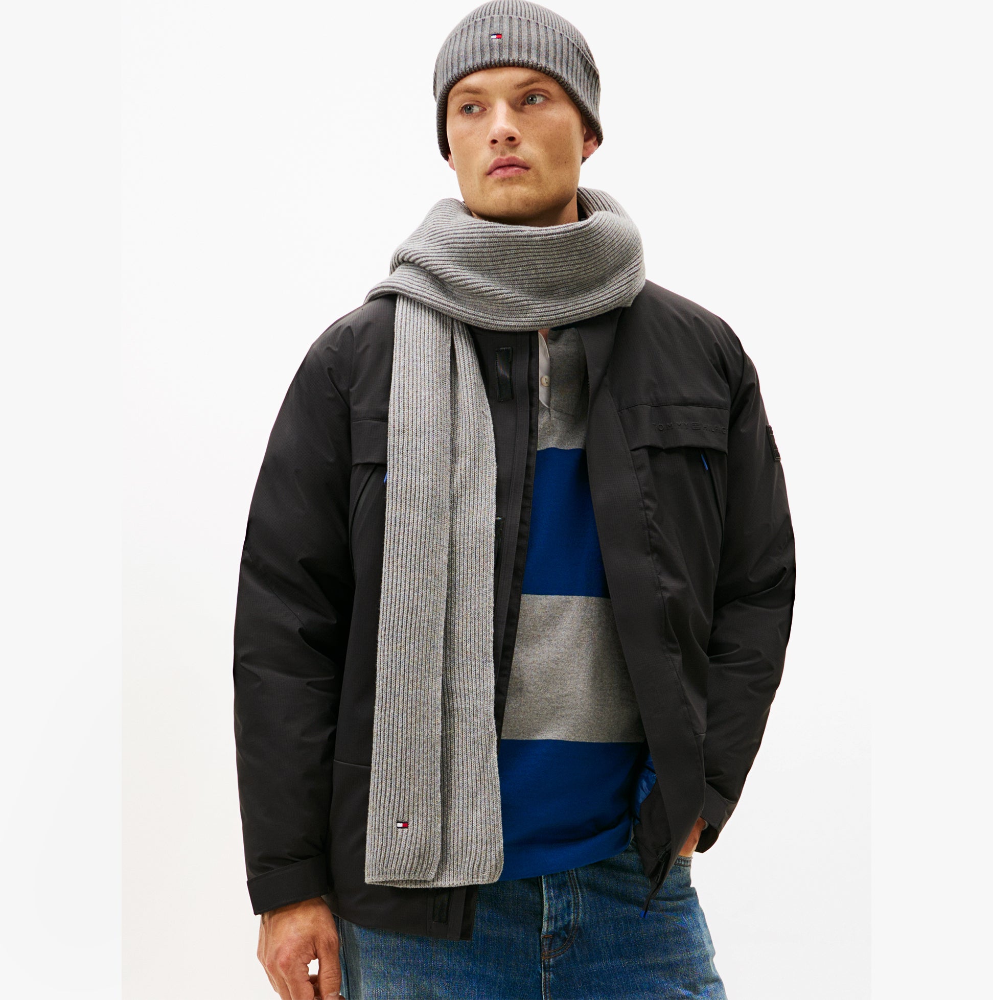 Tommy Hilfiger AM0AM13807 TH FLAG BEANIE & SCA Mens Beanie Mid Grey Heather worn with scarf and jacket, front view.