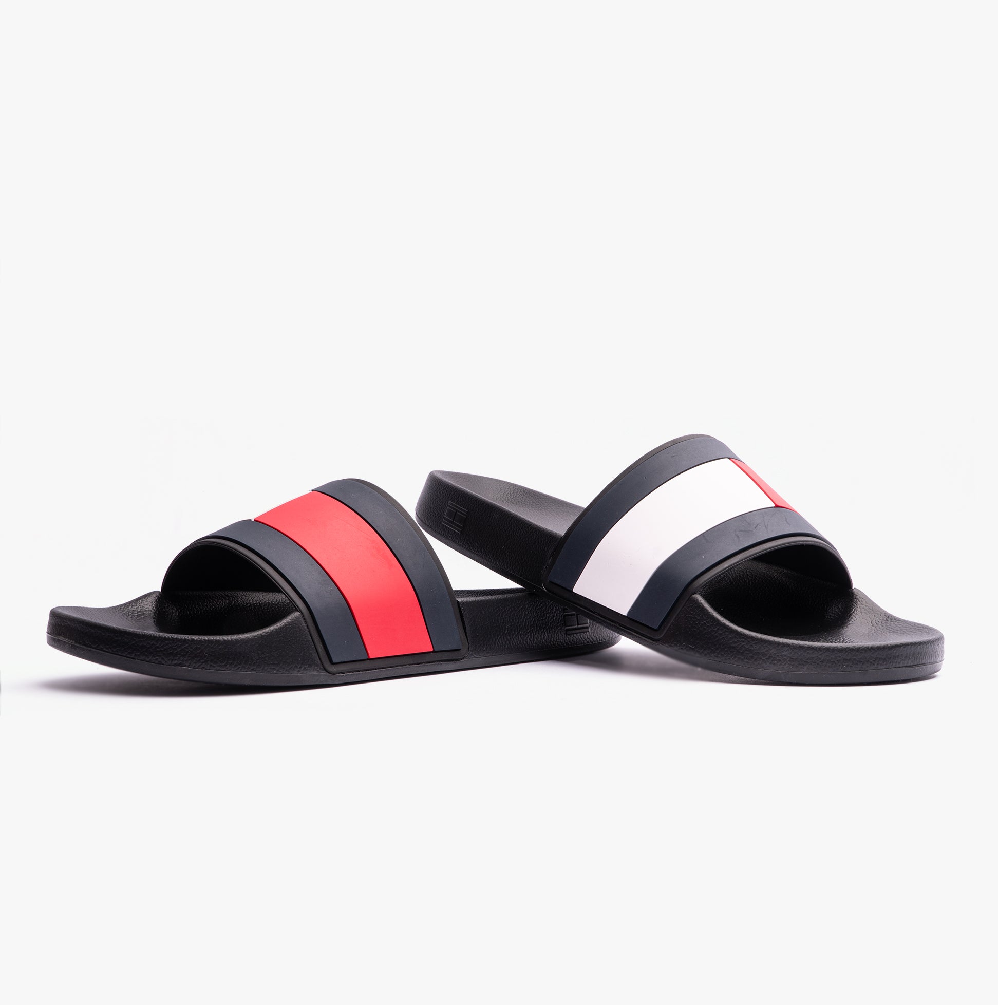 Tommy Hilfiger FLAG Mens Poolside Logo Sliders Desert Black side view with red and white stripes on a black background.