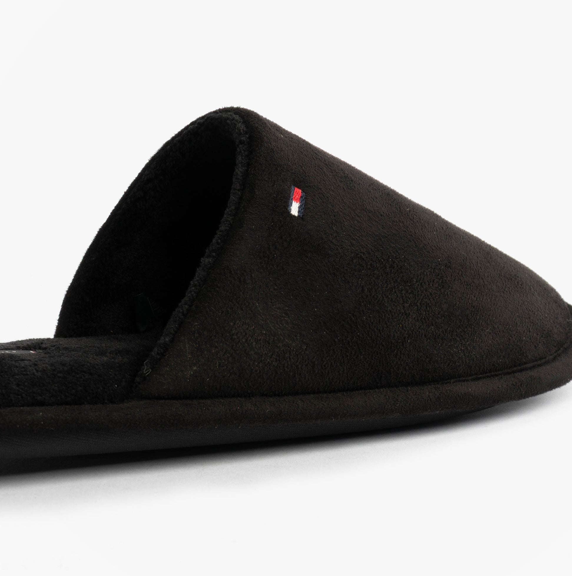 Tommy Hilfiger CORE HILFIGER FLAG H Mens Mule Slippers Black side view, featuring soft textile upper and slip-on design.