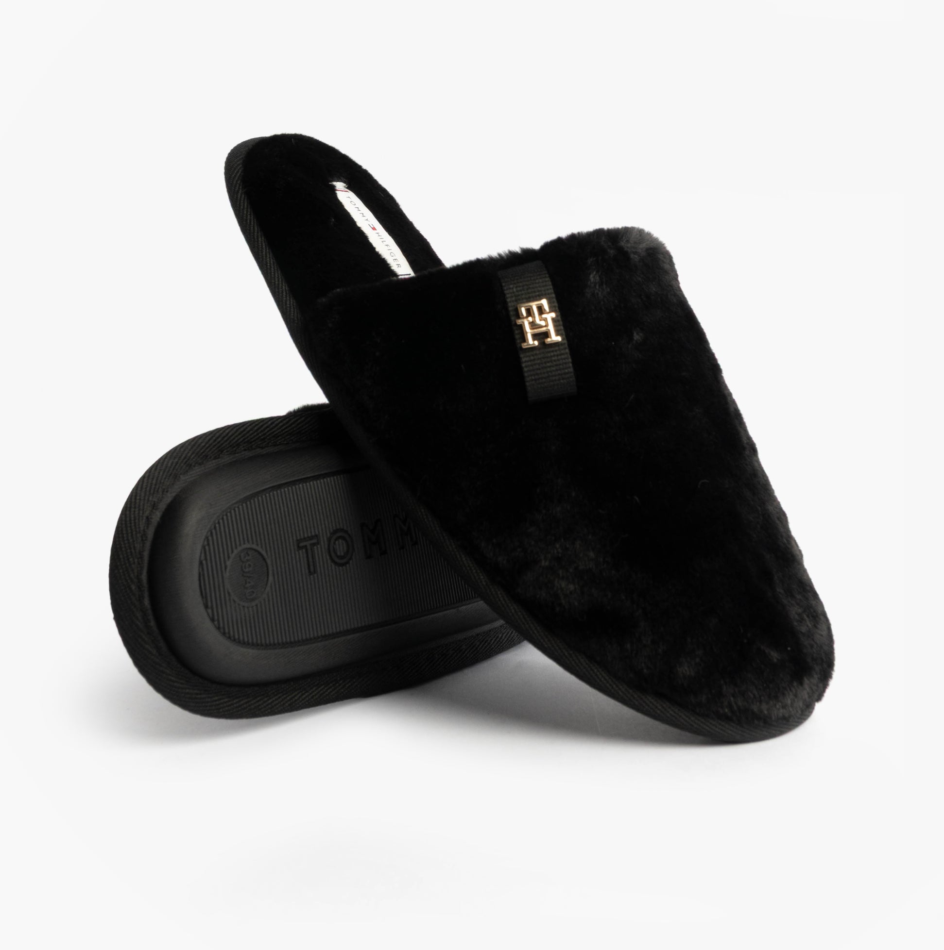 Tommy Hilfiger TH FAUX FUR HOUSE SH Womens Slippers Black side view showing faux fur upper and logo detail.