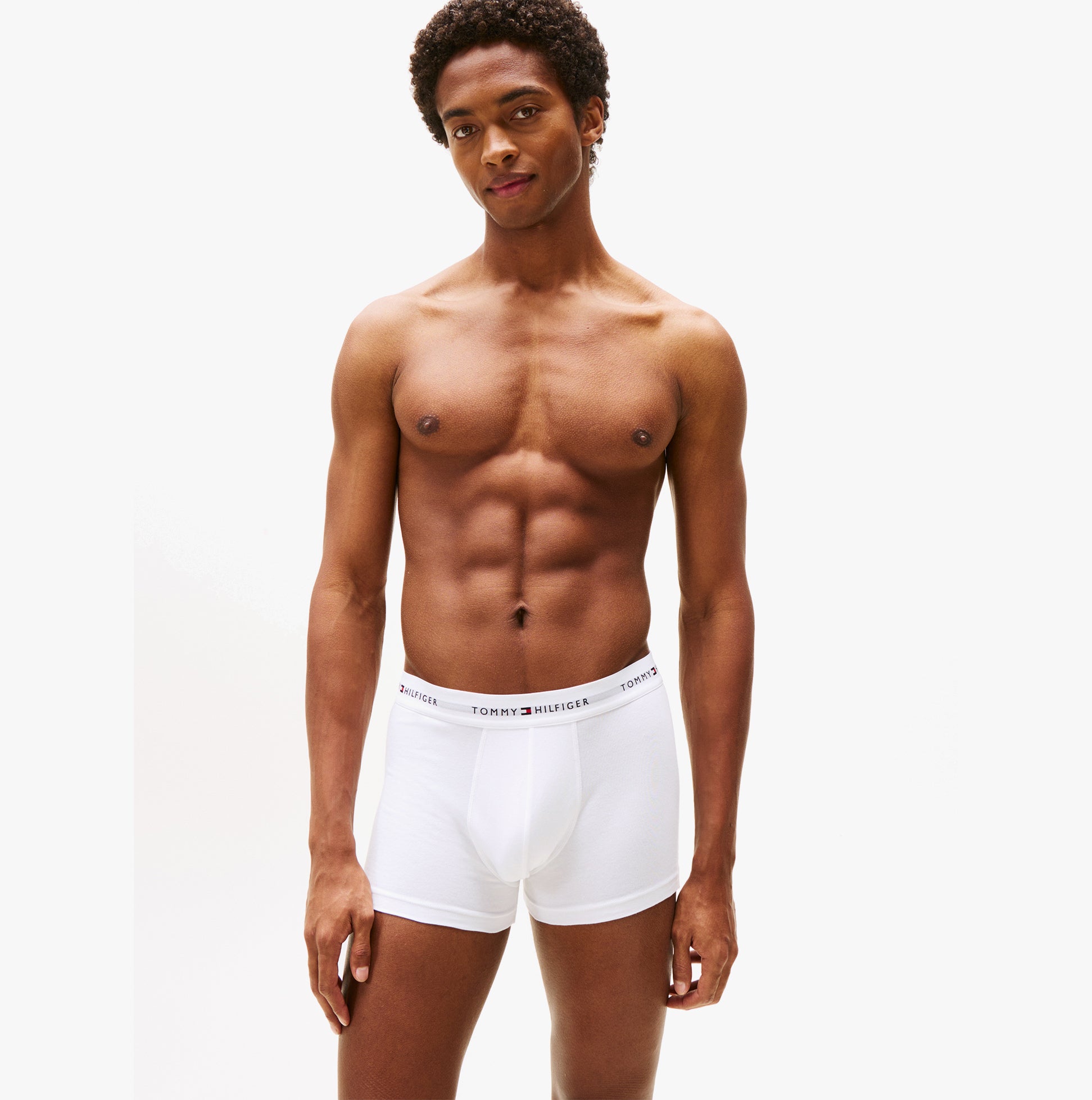 Tommy Hilfiger 3 Pack Trunk Mens White front view model wearing white trunks showcasing fit and design.