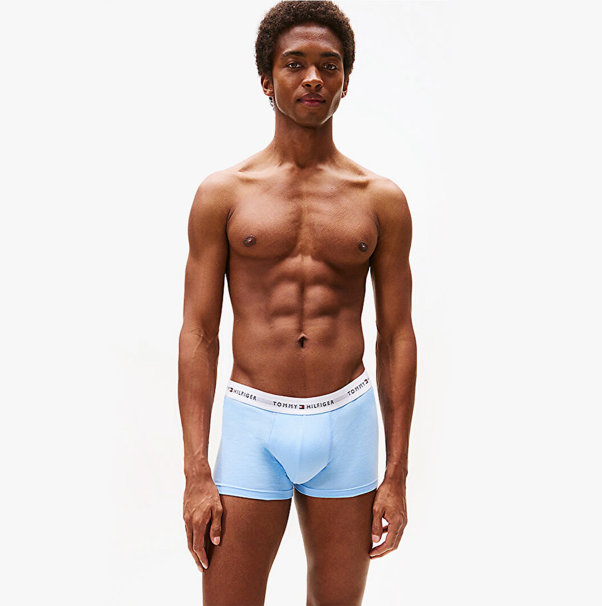 Tommy Hilfiger Mens 3 Pack Logo Waistband Trunks Multi front view on model wearing light blue trunks.