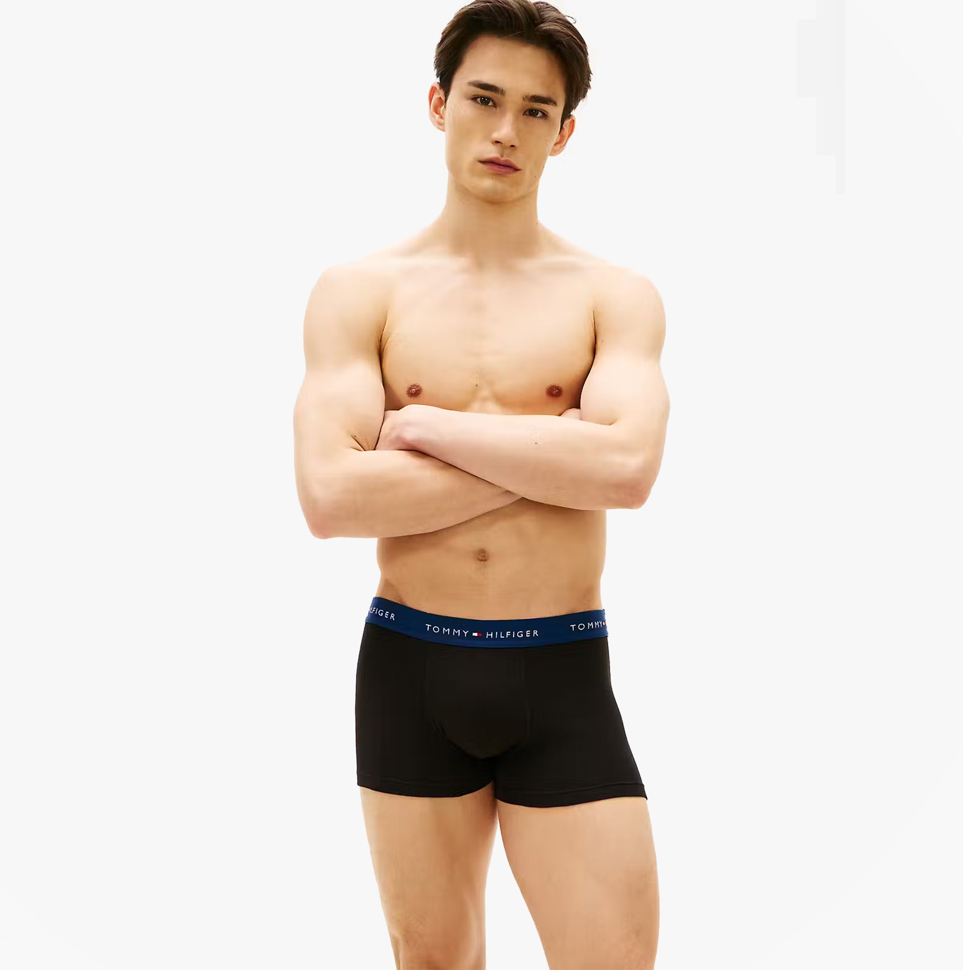 Tommy Hilfiger Mens 3 Pack Signature Repeat Logo Waistband Trunks black front view on model, showcasing the logo waistband.