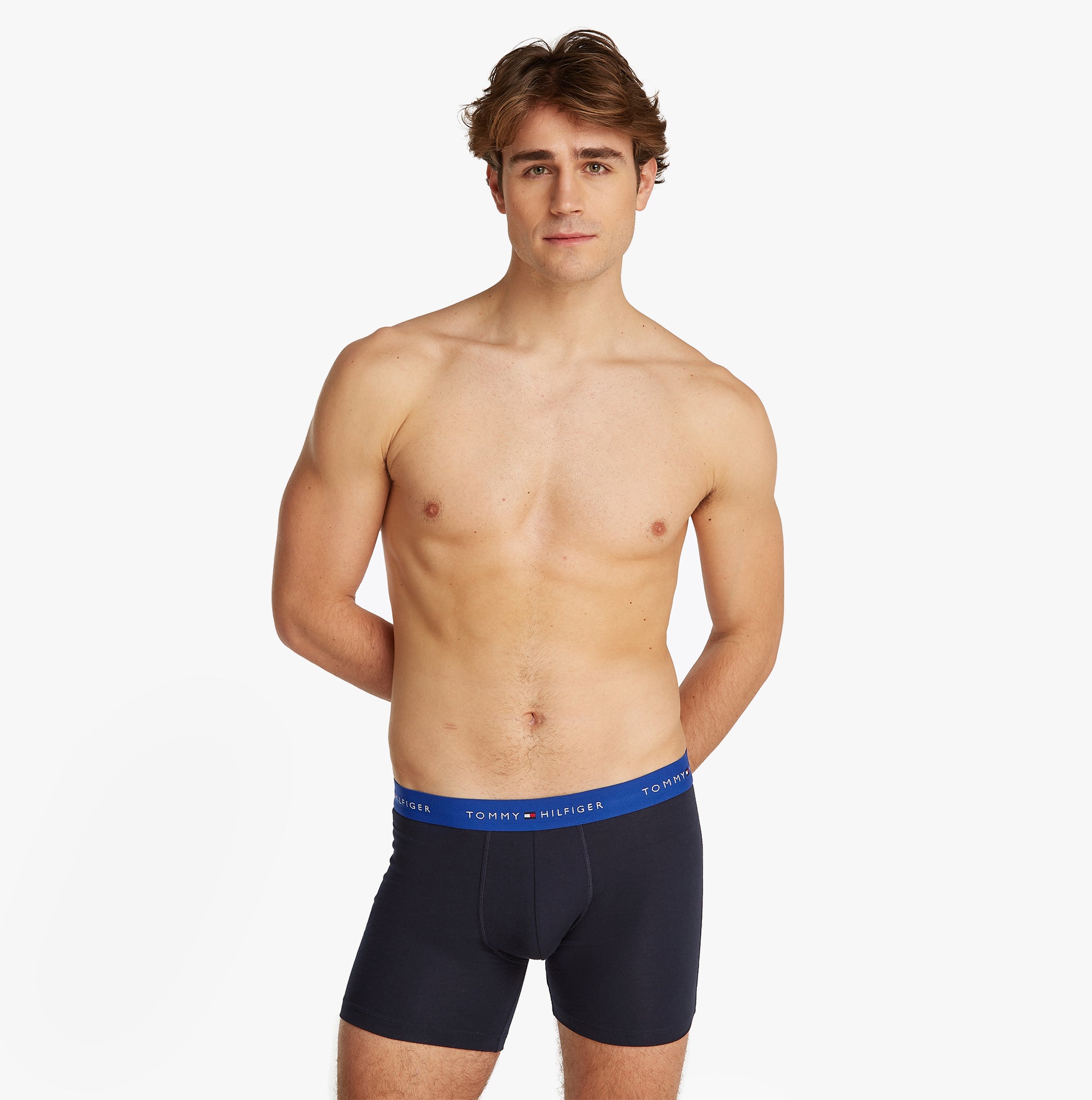 Tommy Hilfiger LOGO 3 Pack Mens Boxer Briefs Multicoloured side view model wearing boxer briefs with logo waistband.