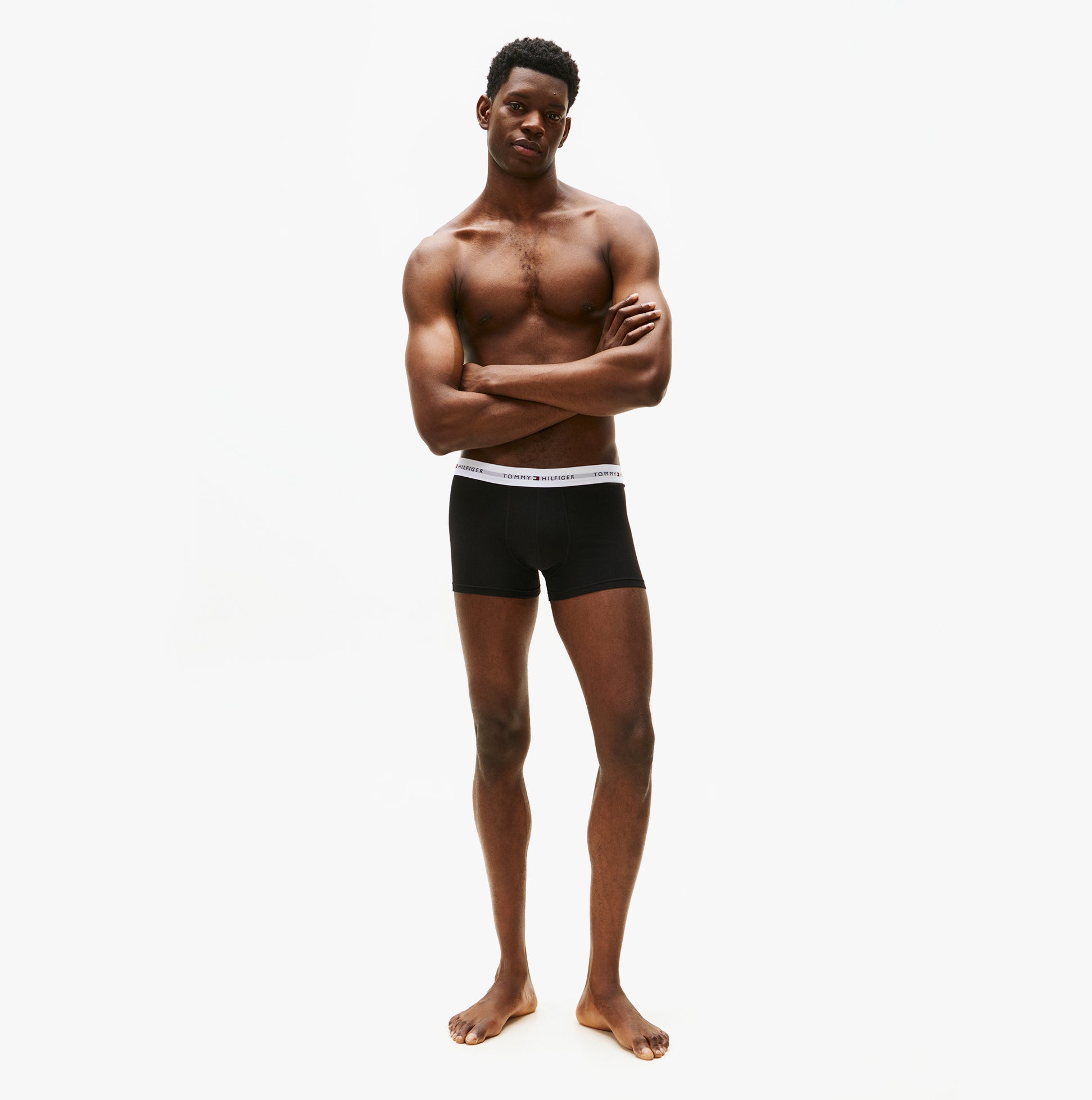 Tommy Hilfiger Mens 3 Pack Trunks Black front view model wearing black trunks, showcasing style and fit.