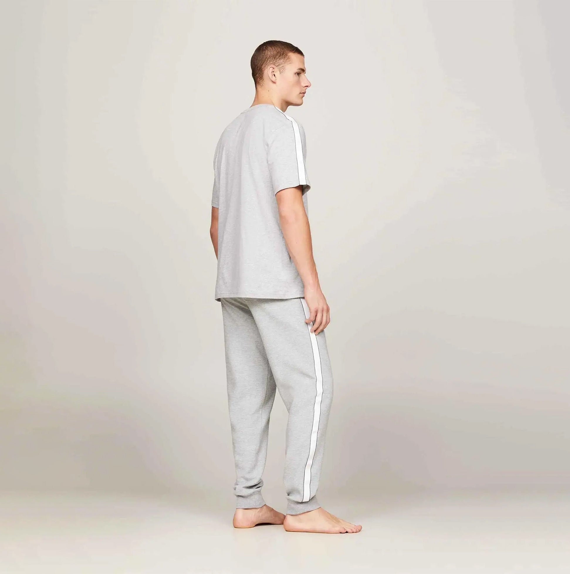 Tommy Hilfiger TEE LOGO Mens Light Grey Ht side view modeling cotton t-shirt and pants with logo details