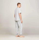 Tommy Hilfiger TEE LOGO Mens Light Grey Ht side view modeling cotton t-shirt and pants with logo details