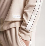 Tommy Hilfiger TH ESTABLISHED Mens Velour Lounge Sweatshirt Cashmere Creme detail view of sleeve and brand label.
