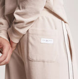 Tommy Hilfiger TH ESTABLISHED Mens Ribbed Velour Lounge Joggers Cashmere Creme side view highlighting pocket detail.