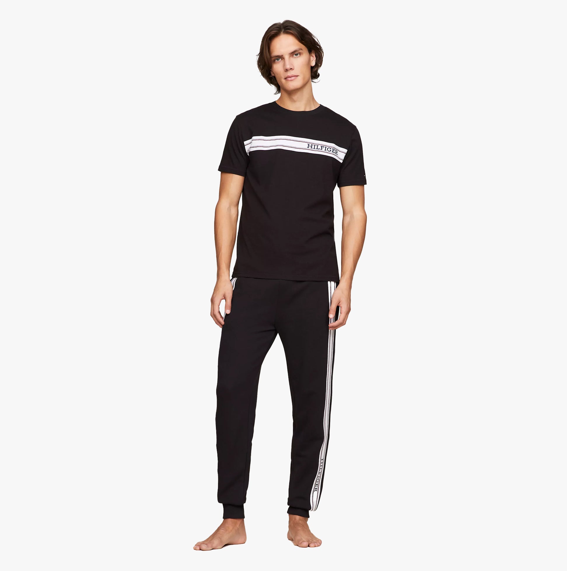 Tommy Hilfiger TEE Mens Black front view, model wearing black t-shirt with logo and black pants.