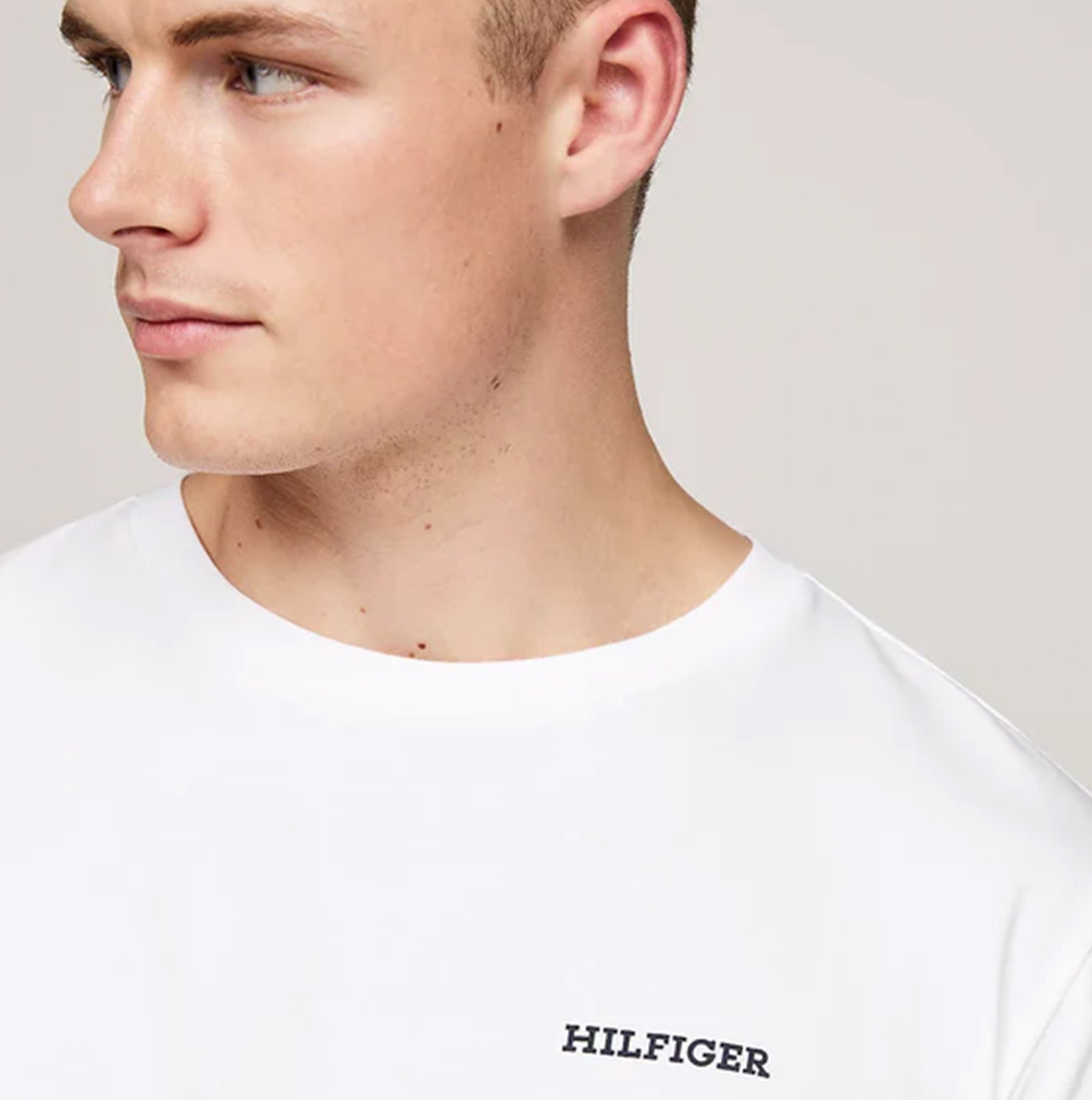 Tommy Hilfiger MONOTYPE Mens Pyjama Set White/Monotype Stripes Indigo side view model wearing white shirt with Hilfiger logo