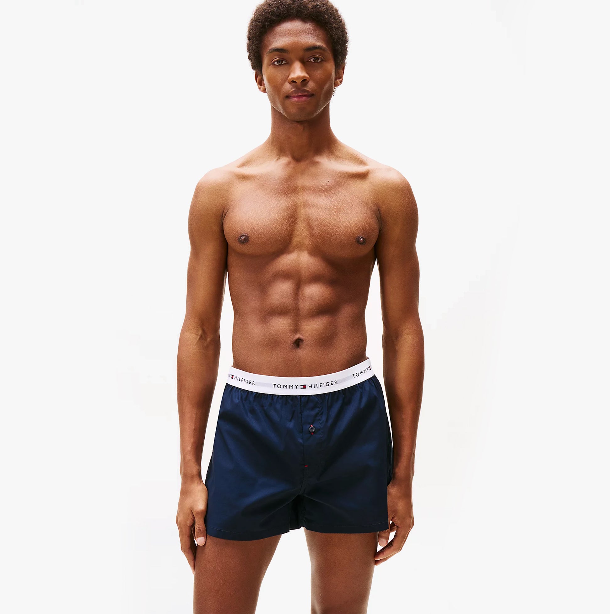 Tommy Hilfiger Mens 2 Pack Signature Logo Woven Boxer Shorts Navy front view on model, showcasing navy color and logo waistband.