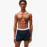 Tommy Hilfiger Mens 2 Pack Signature Logo Woven Boxer Shorts Navy front view on model, showcasing navy color and logo waistband.