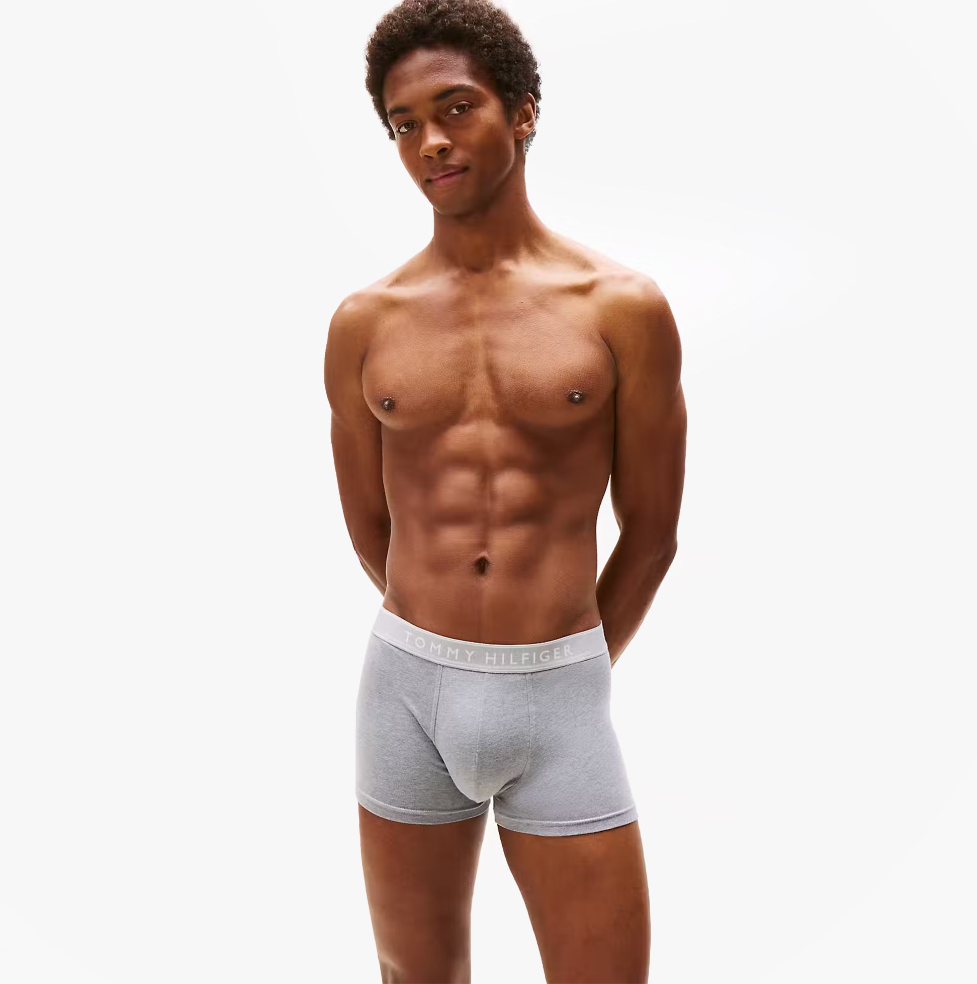 Tommy Hilfiger Mens 3 Pack Trunks Grey/Black/White side view of model wearing grey trunks with logo