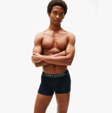 Tommy Hilfiger Mens 3 Pack Logo Waistband Trunks Multi front view with model wearing navy trunks, showcasing logo waistband.