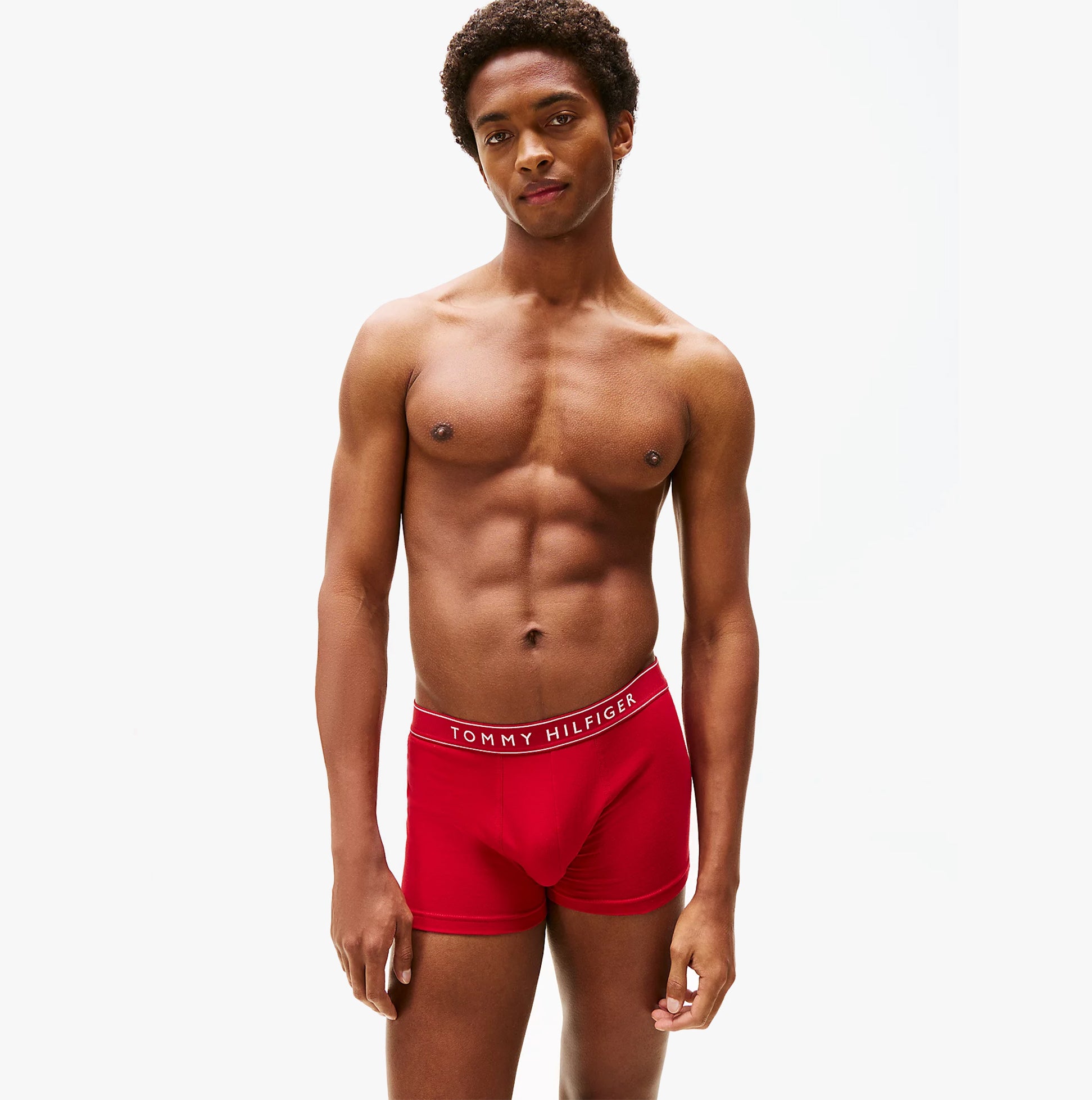 Tommy Hilfiger Mens 3 Pack Logo Waistband Trunks Multi red front view model wearing the trunks with logo waistband.