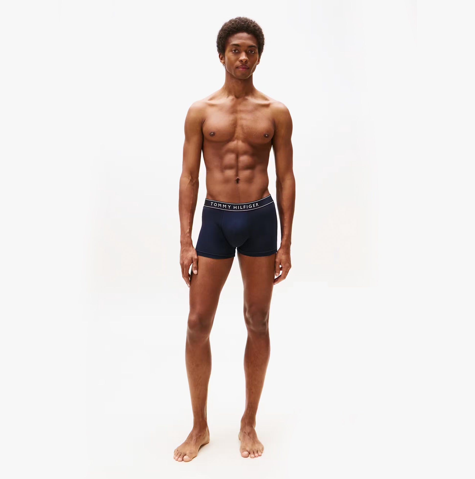 Tommy Hilfiger Mens 3 Pack Logo Waistband Trunks Multi front view on model wearing navy trunks with logo waistband.