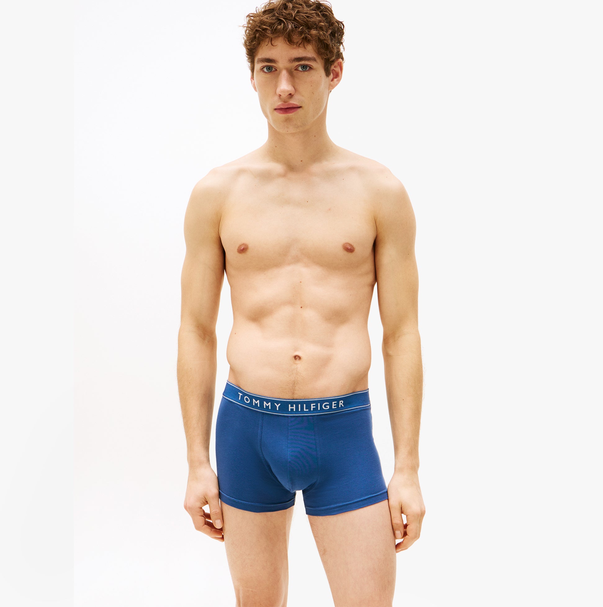 Tommy Hilfiger 3 Pack Mens Trunks Des Sky/Calico/Fssl Blue front view on model showcasing stretch cotton trunk design.