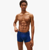 Tommy Hilfiger Mens 3 Pack Logo Waistband Cotton Trunks Multi side view on model wearing blue trunks with logo waistband.
