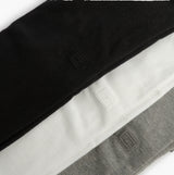 Tommy Hilfiger SS TEE Mens 3-Pack T-Shirts Multicoloured side view of black, white, and grey t-shirts folded neatly.