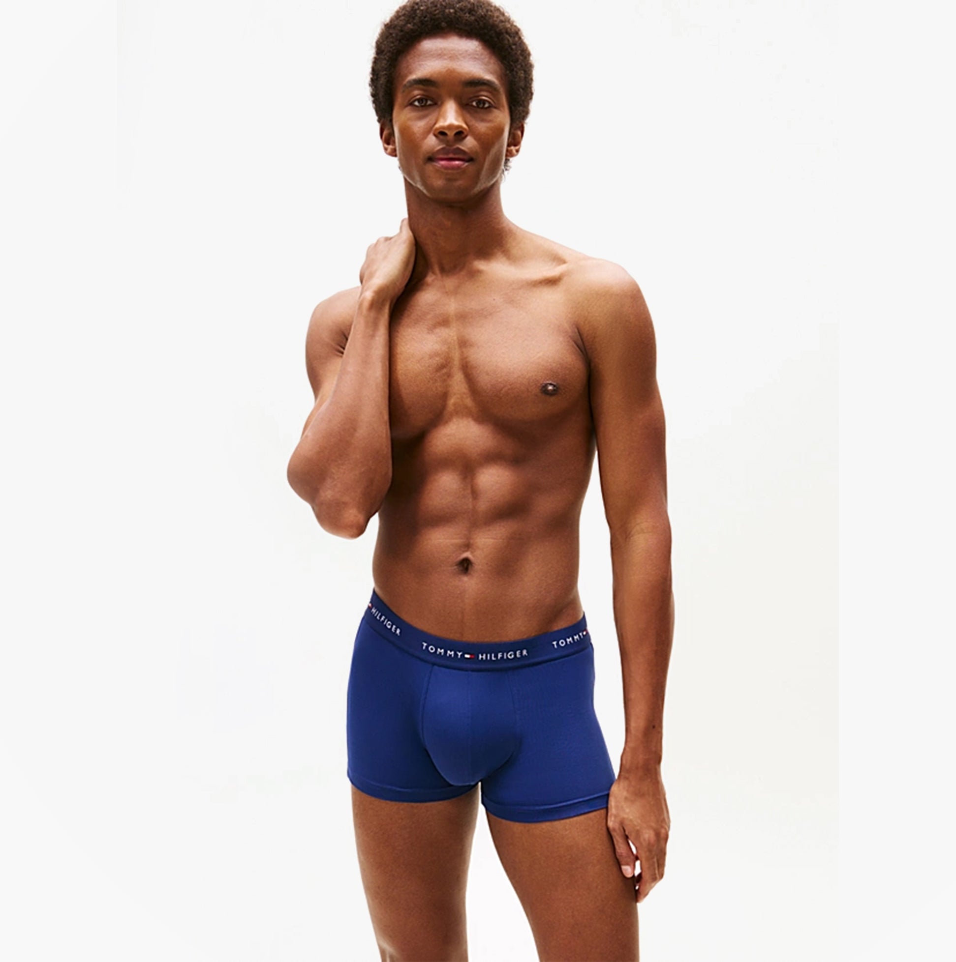 Tommy Hilfiger 3-Pack Signature Mens Microfibre Trunks Multicoloured side view of model wearing navy trunks with logo waistband.