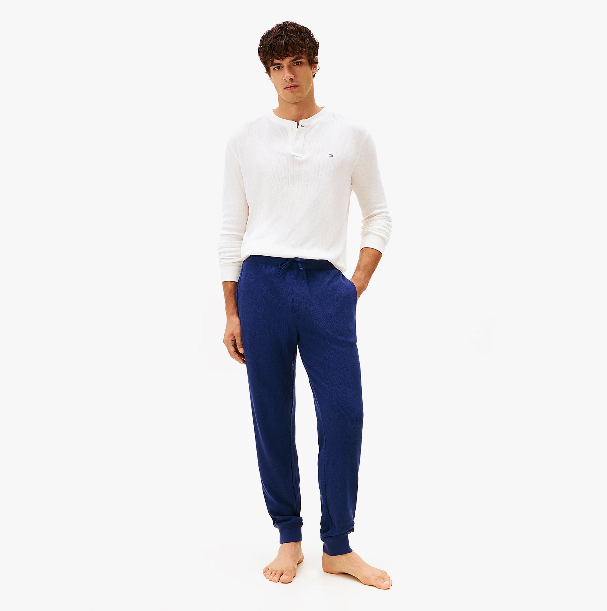 Tommy Hilfiger WAFFLE PANT Mens Cuffed Joggers Navy front view on model wearing a white top.