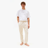 Tommy Hilfiger TH Original Mens Logo Lounge Joggers Off White Newsprint front view on model wearing a white shirt.