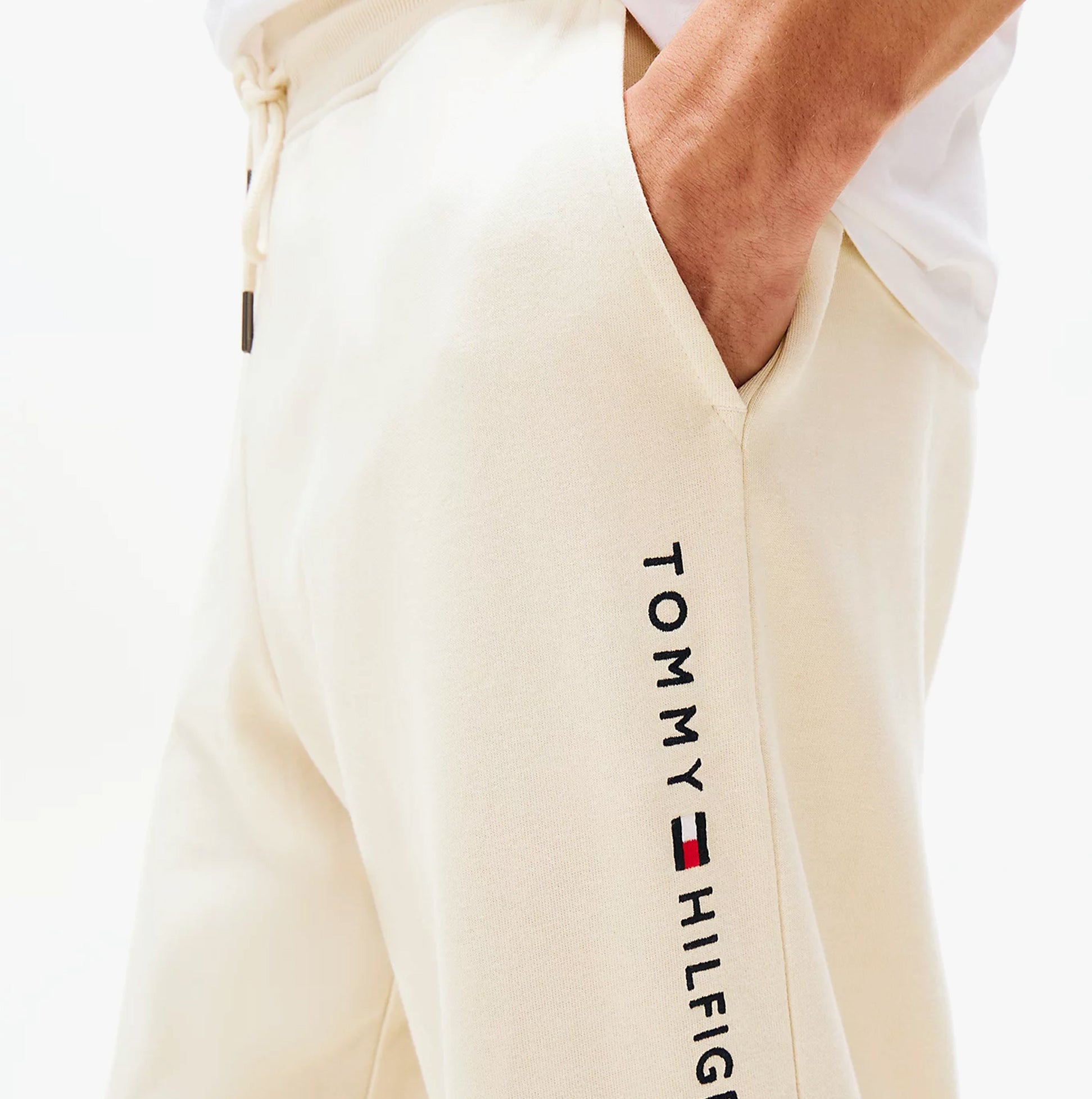 Tommy Hilfiger TH Original Mens Logo Lounge Joggers Off White Newsprint side view with logo detail on leg