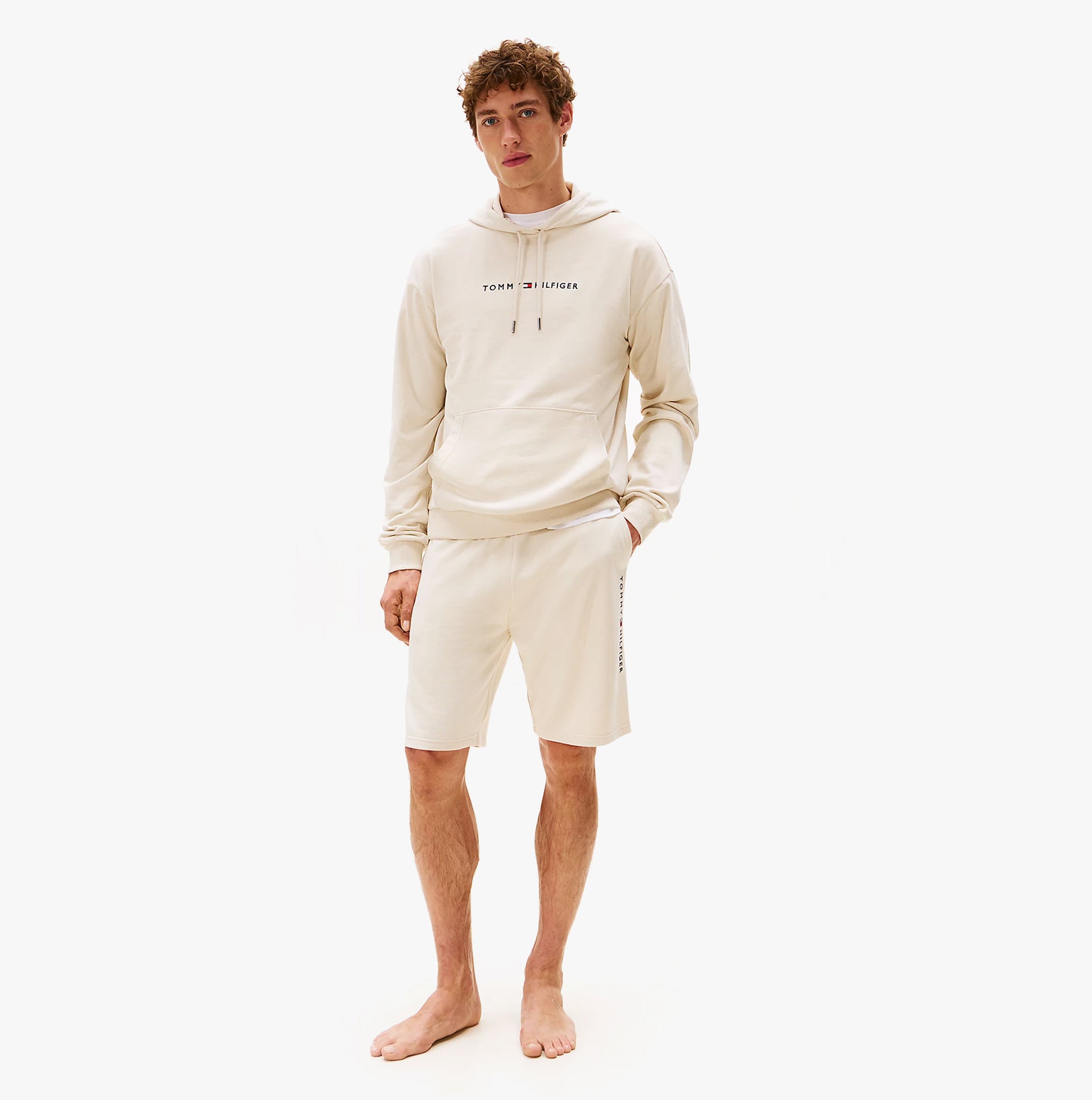 Tommy Hilfiger HOODIE Mens Drawstring Lounge Hoody Off White front view on model, wearing matching shorts, stylish casual outfit.