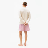 Tommy Hilfiger TRACK TOP Mens Sweatshirts Newsprint back view on model wearing light cream sweatshirt and striped shorts.