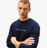 Tommy Hilfiger TRACK TOP Mens Sweatshirts Desert Sky front view model wearing sweatshirt with logo.