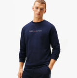 Tommy Hilfiger TRACK TOP Mens Sweatshirts Desert Sky front view, model wearing navy sweatshirt with logo.