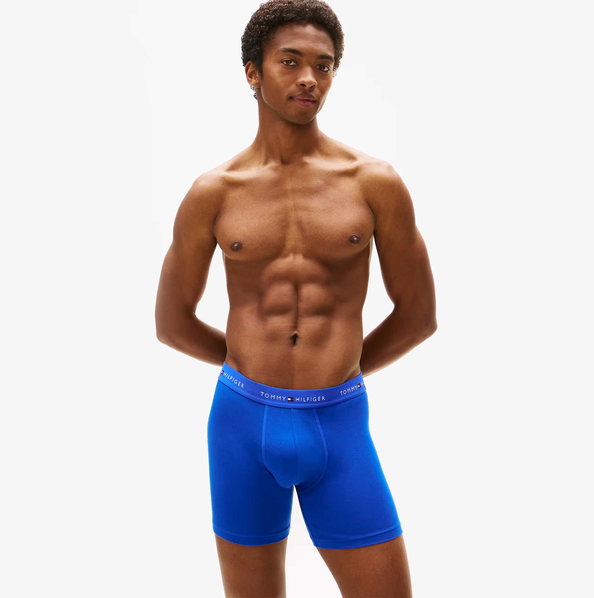 Tommy Hilfiger 3 Pack Mens BOXER BRIEF Multi side view of model wearing blue boxer briefs with logo waistband.