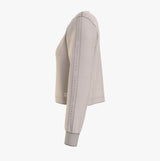 Tommy Hilfiger TRACK TOP Womens Track Top Cashmere Creme side view showcasing long sleeves and stylish design.