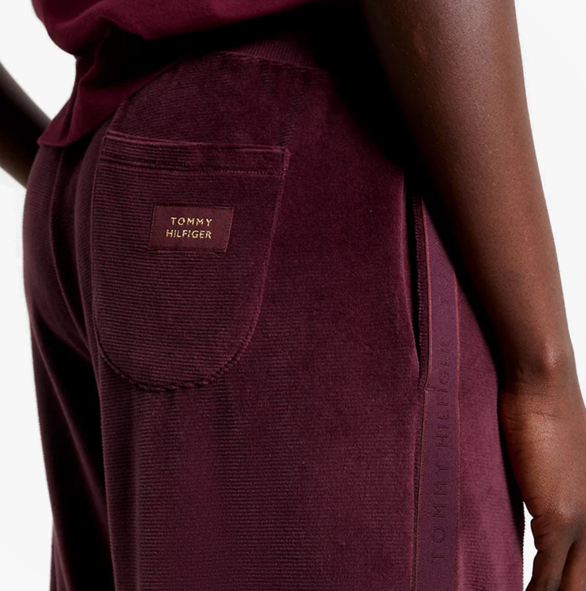 Tommy Hilfiger PANTS VELOUR Womens Pants Deep Burgundy detail view showcasing back pocket with logo.