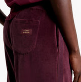 Tommy Hilfiger PANTS VELOUR Womens Pants Deep Burgundy detail view showcasing back pocket with logo.